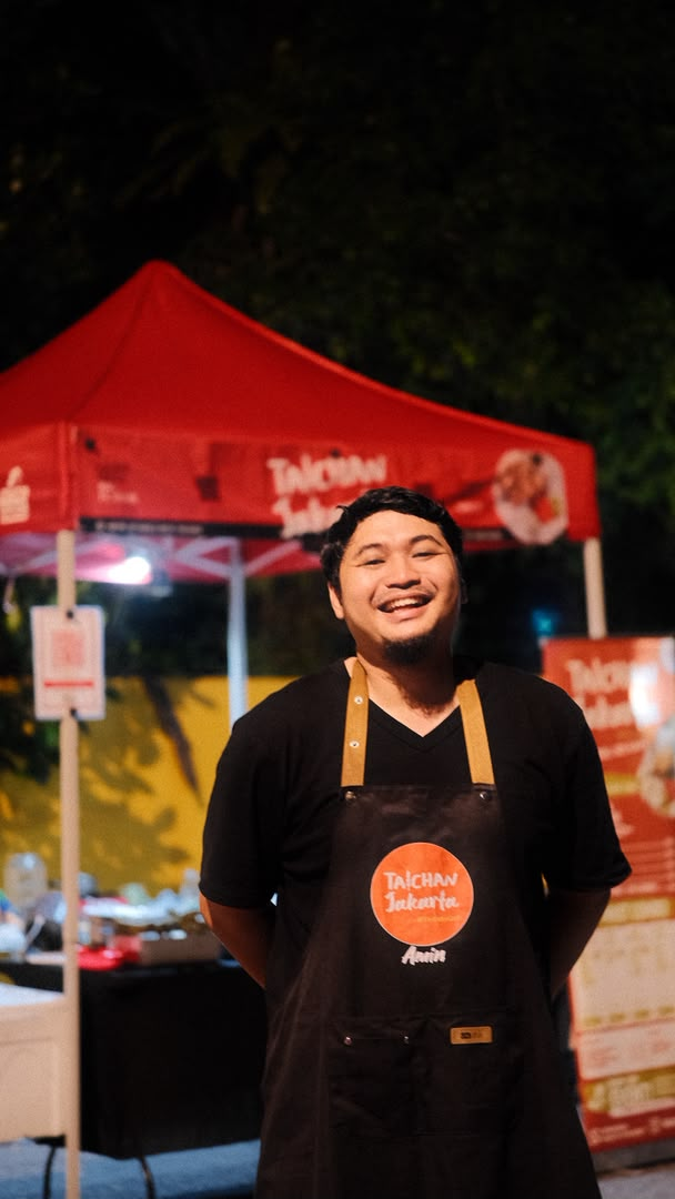 Taichan Jakarta crew member Amin in front of the tent