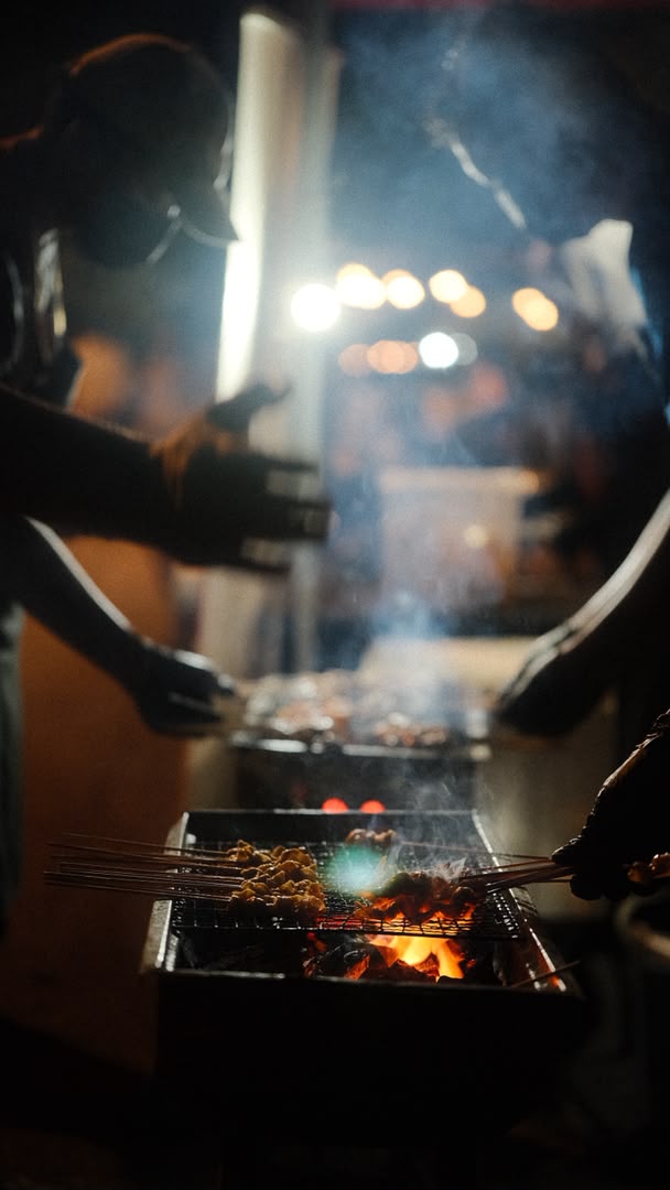 Taichan Jakarta team grilling sate over charcoal